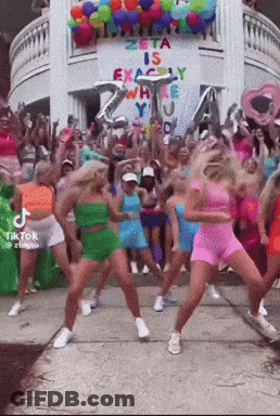 A Group Of Women Are Dancing In Front Of A Sign That Says Zeta Is Exactly Where You 'Re Going GIF