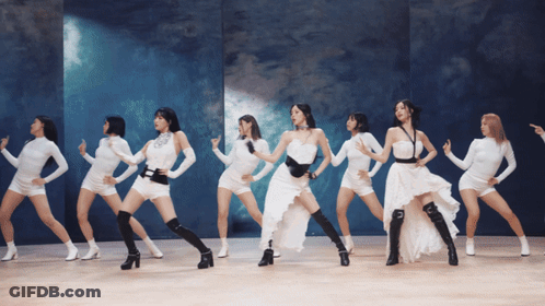 A Group Of Women Are Dancing In White Dresses GIF