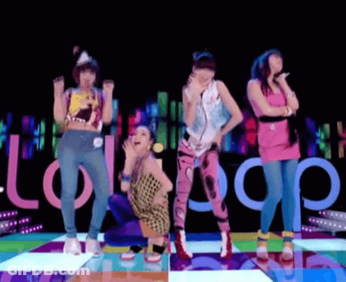 A Group Of Women Are Dancing On A Colorful Dance Floor With The Word Lollipop In The Background GIF