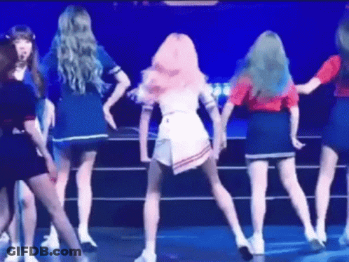 A Group Of Women Are Dancing On A Stage In A Circle . GIF