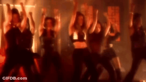 Women Dancing On Stage In Dark Room GIF