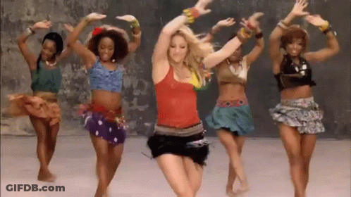 A Group Of Women Are Dancing Together In Front Of A Wall In A Room . GIF