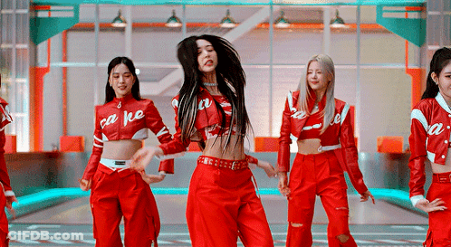 A Group Of Women Are Dancing Together In Red Outfits . GIF