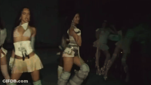 A Group Of Women Are Dancing Together In The Dark GIF