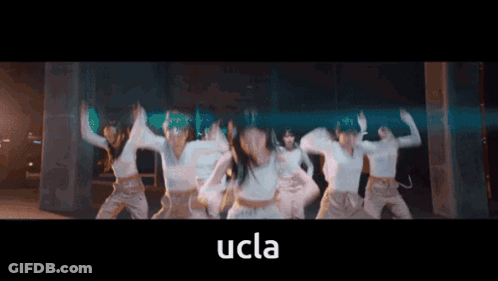 A Group Of Women Are Dancing With The Word Ucla In The Corner GIF