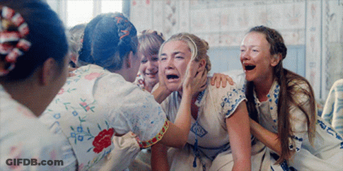 A Group Of Women Are Laughing And One Of Them Is Crying With Her Mouth Open GIF