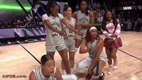 A Group Of Women Are On A Basketball Court Wearing Jerseys That Say Quantum GIF