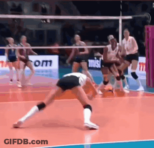 A Group Of Women Are Playing Volleyball On A Court With A Sign That Says Om GIF