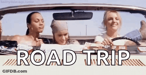 A Group Of Women Are Sitting In A Car With The Words `` Road Trip '' Written On The Side . GIF