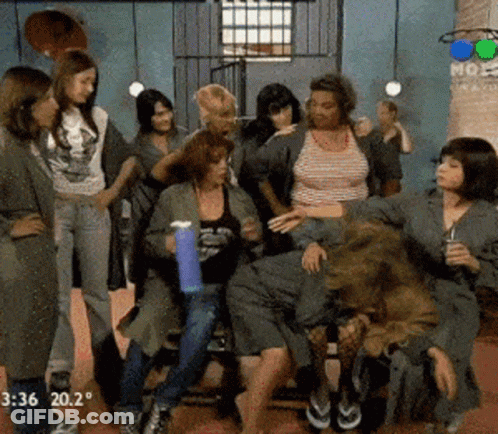 A Group Of Women Are Standing And Sitting In A Room With The Time Of 3:36 GIF