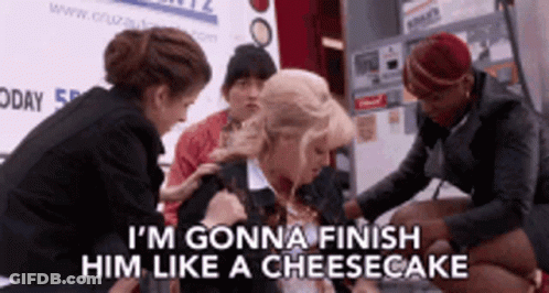 A Group Of Women Are Standing Around A Woman Who Says I 'M Gonna Finish Him Like A Cheesecake .. GIF