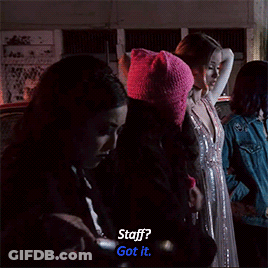 A Group Of Women Are Standing In A Dark Room And One Of Them Says " Staff ? Got It " GIF