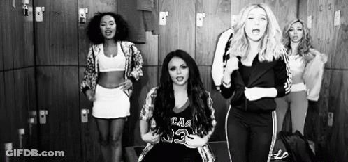 A Group Of Women Are Standing In A Locker Room Dancing . GIF