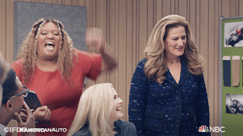 Women Standing In Room With NBC Logo GIF