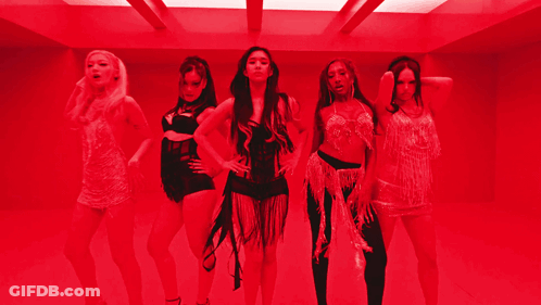 A Group Of Women Are Standing In A Room With Red Lights GIF
