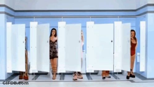 A Group Of Women Are Standing In A Row In A Bathroom GIF