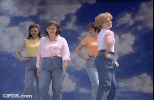 A Group Of Women Are Standing In Front Of A Cloudy Sky GIF