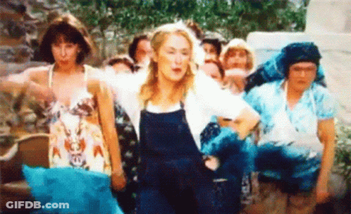 A Group Of Women Are Standing Next To Each Other And Dancing In A Field . GIF