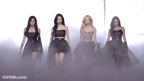 A Group Of Women Are Standing Next To Each Other In A Foggy Area GIF