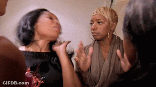 A Group Of Women Are Standing Next To Each Other In A Room . GIF