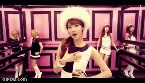 A Group Of Women Are Standing Next To Each Other In A Room . One Of The Women Is Wearing A Fur Hat . GIF