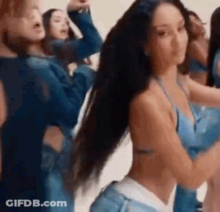 A Group Of Women Are Standing Next To Each Other In A Room . GIF
