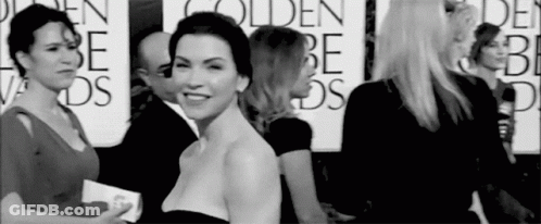 A Group Of Women Are Standing Next To Each Other On A Red Carpet At A Golden Globes Event . GIF