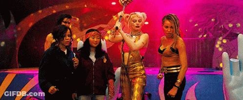 A Group Of Women Are Standing Next To Each Other On A Stage Holding A Microphone . GIF