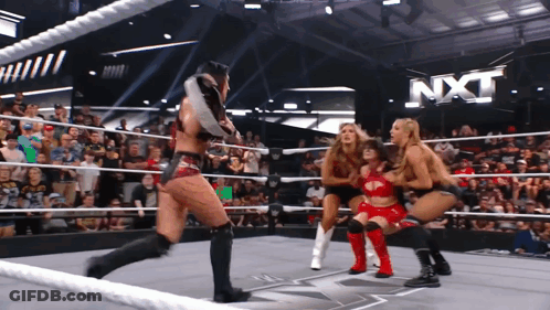 A Group Of Women Are Wrestling In A Ring With Nxt Written In The Background GIF