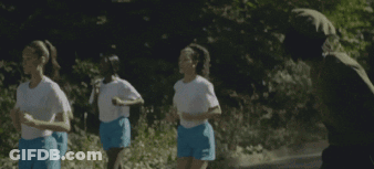 A Group Of Women In Blue Shorts Are Running On A Road GIF