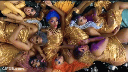 A Group Of Women In Gold Dresses Are Laying Down GIF