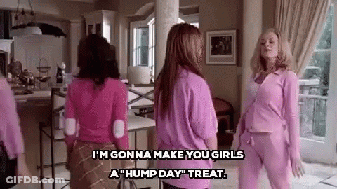 A Group Of Women In Pink Clothes Are Standing In A Living Room Talking To Each Other . GIF
