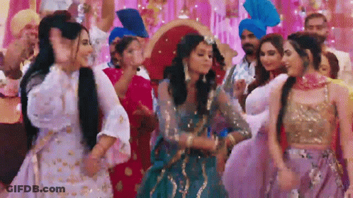 A Group Of Women In Traditional Dresses Are Dancing At A Party . GIF