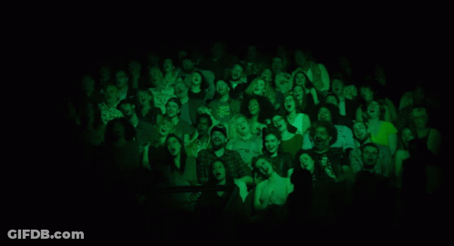 A Group Of Women Singing In Front Of Microphones On A Stage GIF