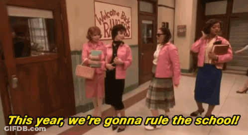 A Group Of Women Standing In A Hallway With The Words " This Year We 'Re Gonna Rule The School " In Yellow Letters GIF