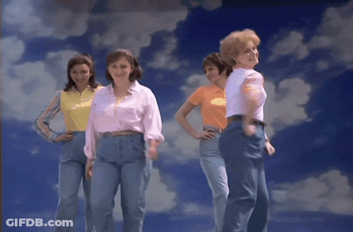 A Group Of Women Standing In Front Of A Blue Sky With Clouds GIF