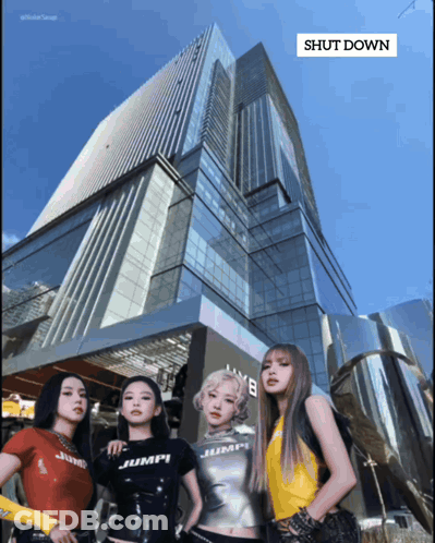 A Group Of Women Standing In Front Of A Building That Says " Shut Down " On It GIF
