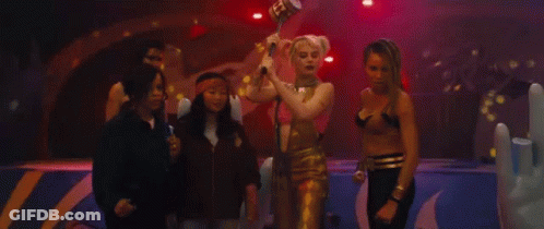 A Group Of Women Standing Next To Each Other On A Stage In A Dark Room . GIF