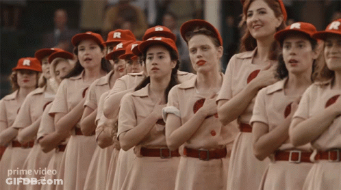 A Group Of Women Wearing R Hats Stand In A Line GIF