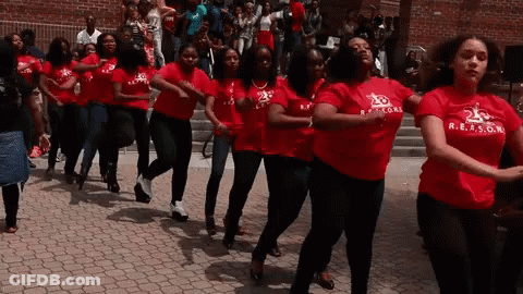 A Group Of Women Wearing Red Shirts With R.e.a.s.g.n. On Them GIF