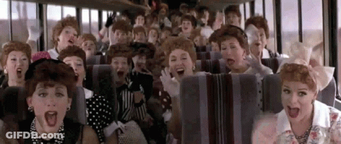 A Group Of Women Wearing Wigs Are Sitting On A Bus . GIF