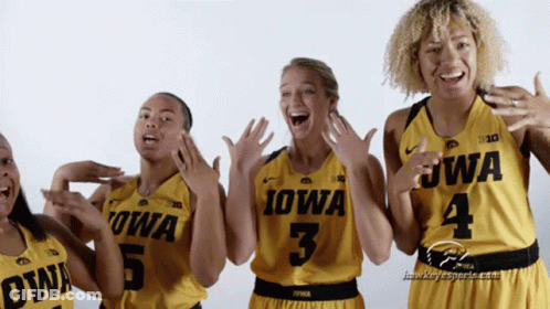 A Group Of Women Wearing Yellow Iowa Jerseys GIF