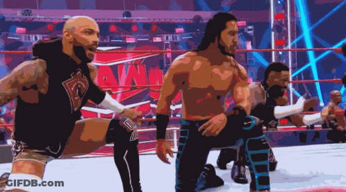 A Group Of Wrestlers Are Kneeling Down In Front Of A Ring That Says Wwe GIF