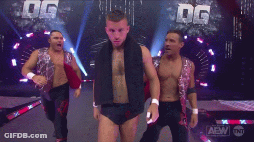 A Group Of Wrestlers Are On A Stage With The Letters Dg Behind Them GIF