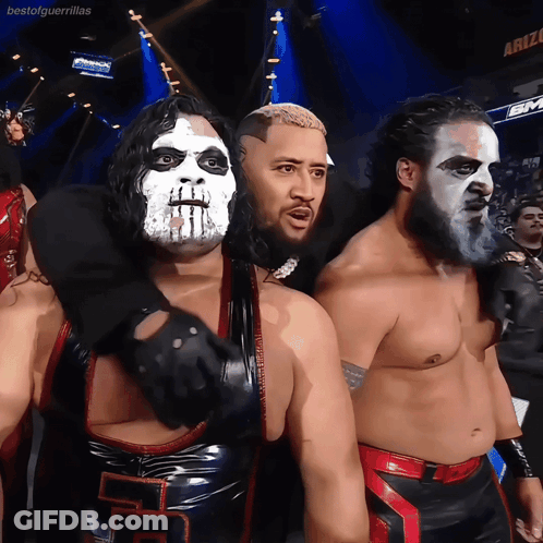 A Group Of Wrestlers Are Posing For A Picture In Front Of A Sign That Says Bestofguerrillas GIF