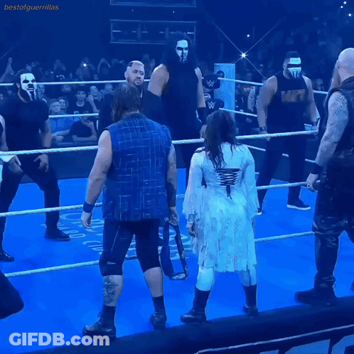 A Group Of Wrestlers Are Standing In A Ring And One Of Them Is Wearing A Shirt That Says Mcw GIF