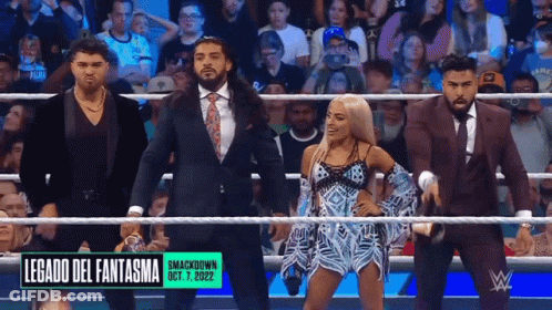 A Group Of Wrestlers Are Standing In A Ring With A Sign That Says Legado Del Fantasma On It GIF