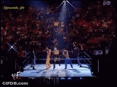 A Group Of Wrestlers Are Standing In A Ring With Fireworks Coming Out Of It GIF