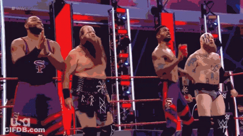 A Group Of Wrestlers Are Standing In A Ring With The Letters Usa On Their Pants GIF