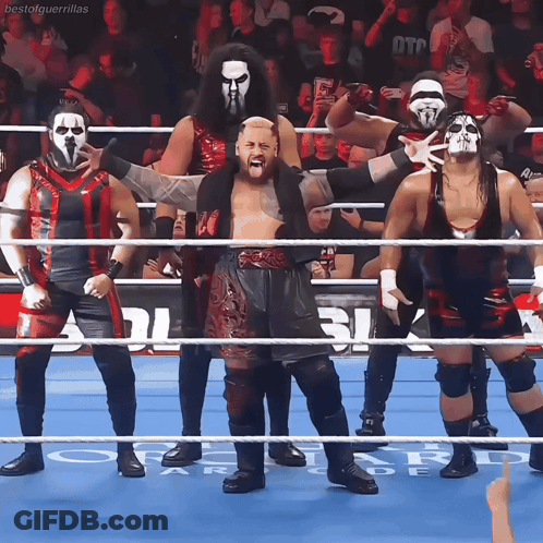 A Group Of Wrestlers Are Standing In A Ring With The Word Bestal Guerrillas On The Bottom Right GIF